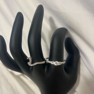 Two silver tone rings, 8.5 and 9.5, both with rhinestones.